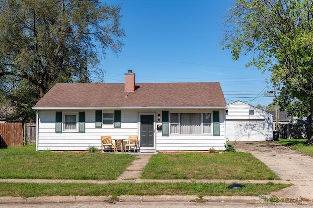 ranch-style house with a garage and a front lawn