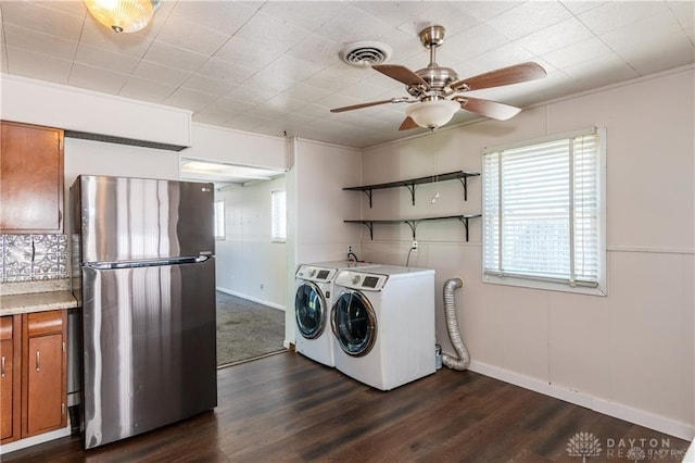 laundry room with dark wood-type flooring, washing machine and dryer, and ceiling fan