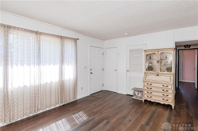 unfurnished bedroom featuring dark hardwood / wood-style flooring