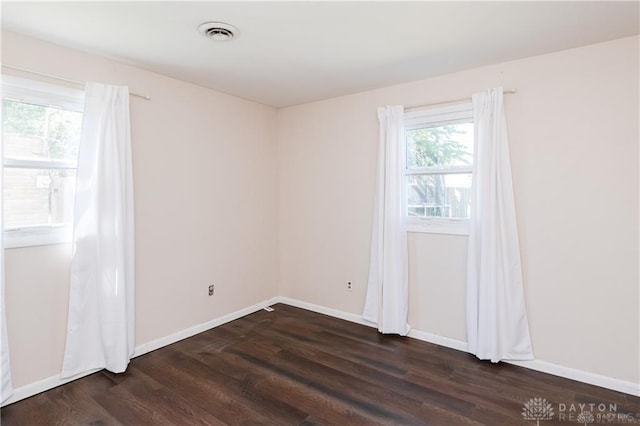 unfurnished room featuring dark hardwood / wood-style floors