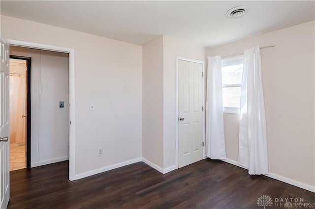 unfurnished bedroom with dark hardwood / wood-style floors