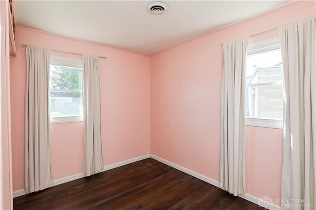 spare room featuring dark hardwood / wood-style floors