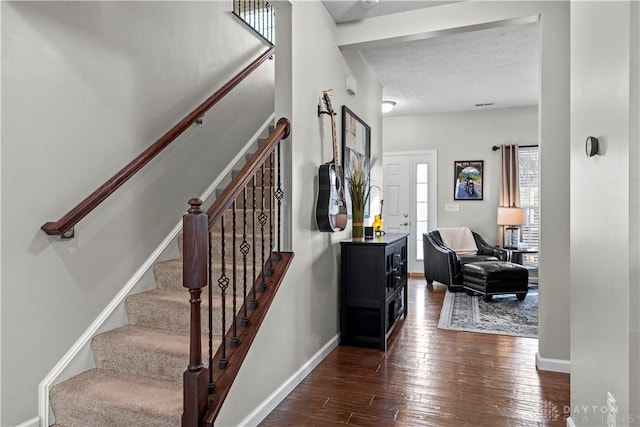 interior space featuring dark hardwood / wood-style floors and a textured ceiling