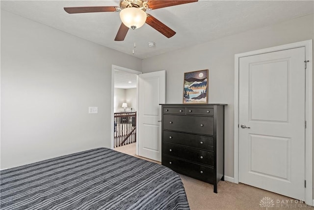 bedroom with light carpet and ceiling fan