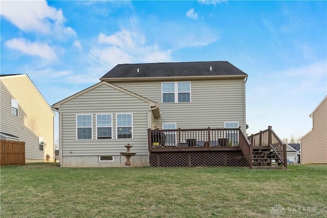 rear view of house with a deck and a lawn