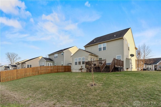 rear view of property with a yard and a deck