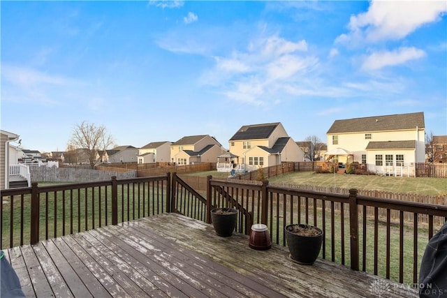 wooden terrace featuring a lawn