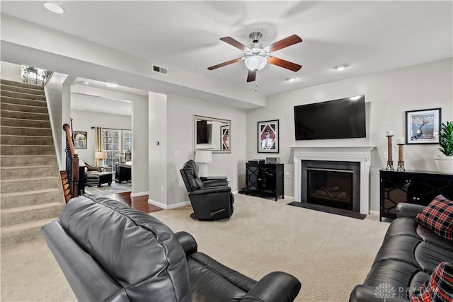 carpeted living room featuring ceiling fan