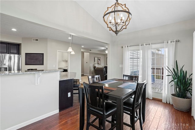 dining area with lofted ceiling, dark hardwood / wood-style floors, and ceiling fan with notable chandelier