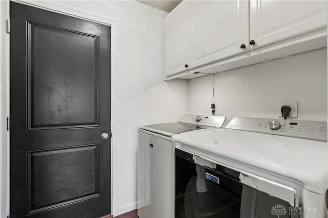 laundry room with cabinets and washing machine and clothes dryer