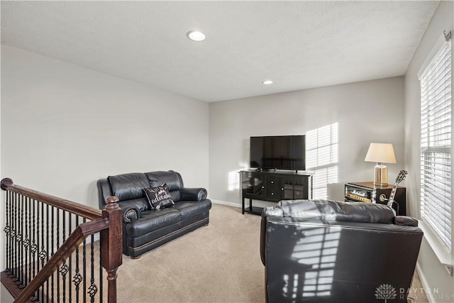 living room with light carpet and a textured ceiling