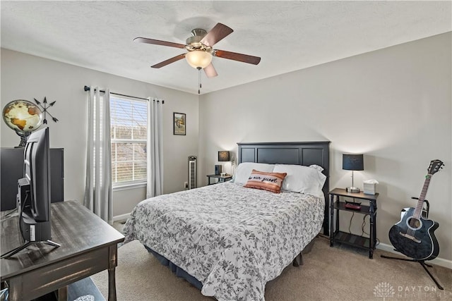 bedroom featuring ceiling fan, carpet, and a textured ceiling