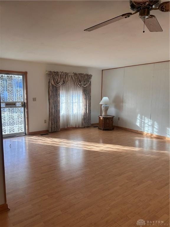 empty room featuring ceiling fan and wood-type flooring