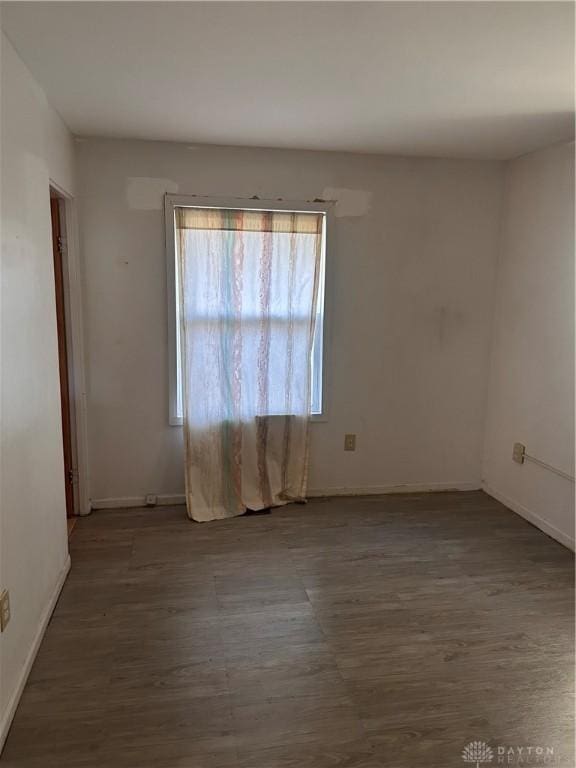 empty room with hardwood / wood-style floors