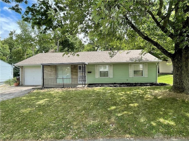 ranch-style home with a garage, a porch, and a front yard