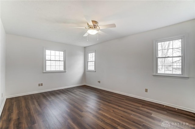 empty room featuring ceiling fan and dark hardwood / wood-style floors