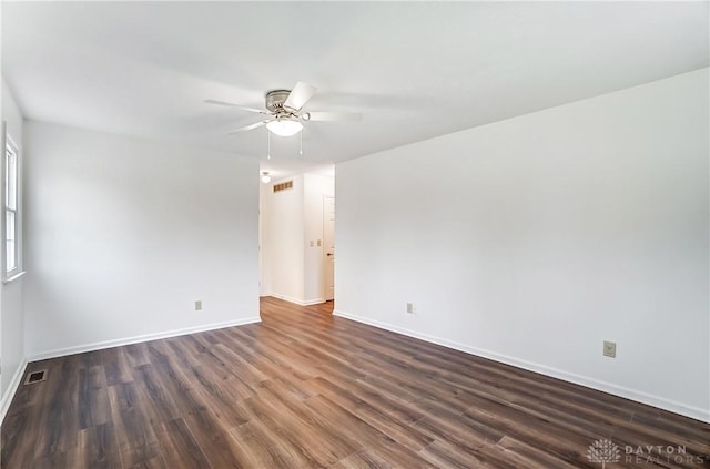 unfurnished room featuring ceiling fan and dark wood-type flooring