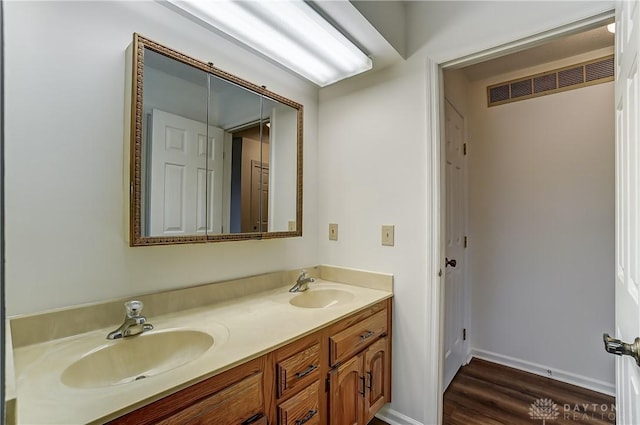 bathroom with hardwood / wood-style floors and vanity