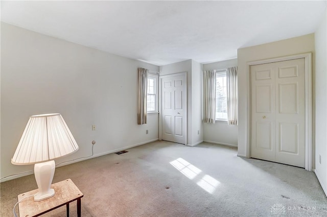 unfurnished bedroom with light carpet