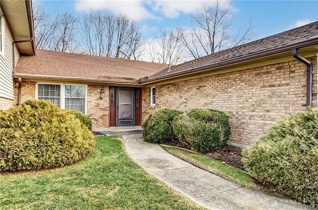 property entrance with a lawn