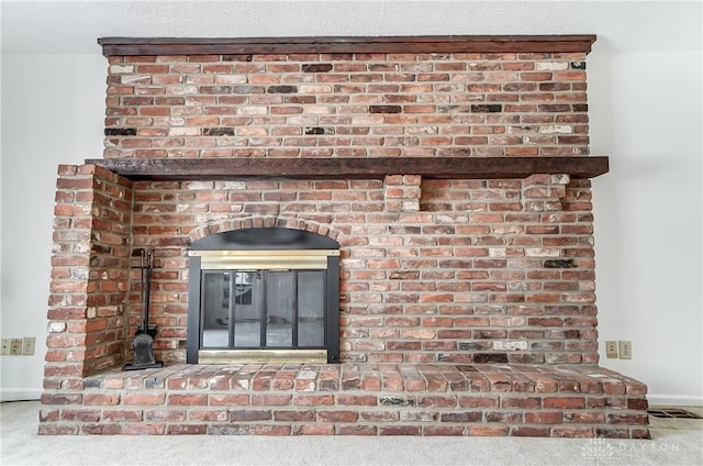 room details with a brick fireplace and carpet flooring