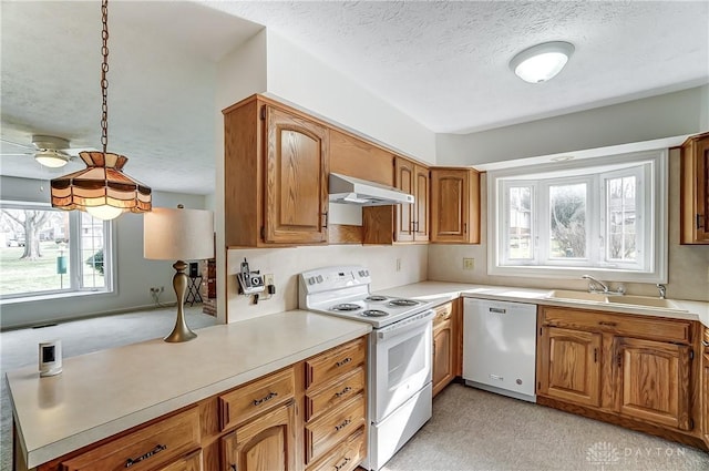 kitchen featuring dishwashing machine, electric stove, sink, a textured ceiling, and hanging light fixtures