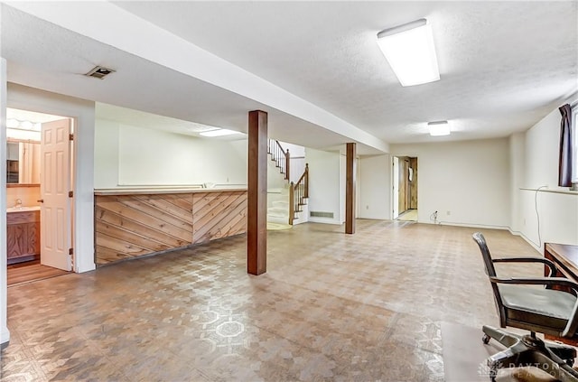 basement with sink and a textured ceiling