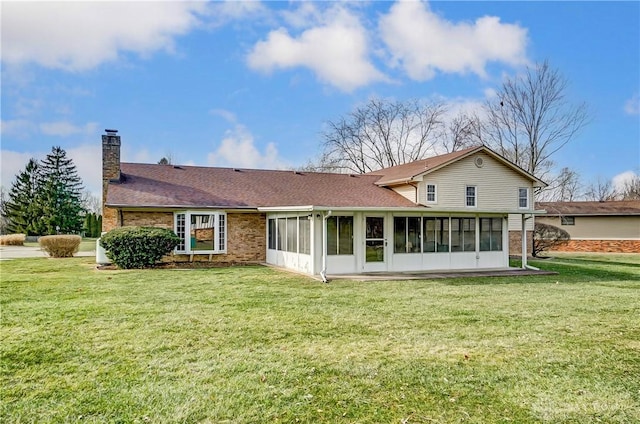 back of property featuring a yard and a sunroom