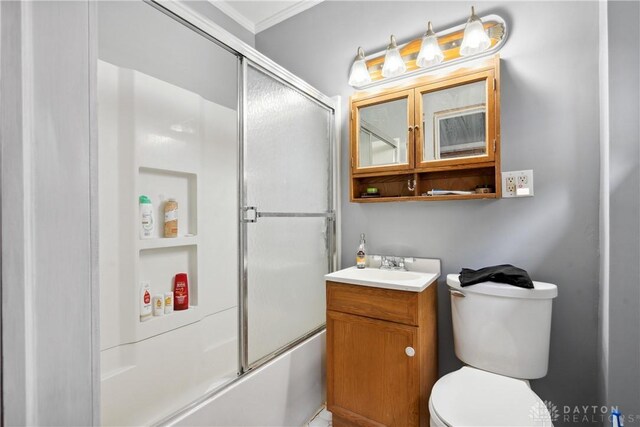 full bathroom with vanity, toilet, and combined bath / shower with glass door