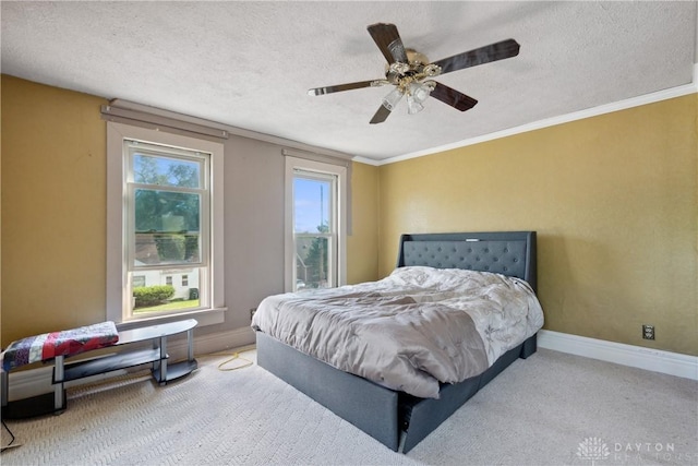 bedroom with crown molding, ceiling fan, carpet, and a textured ceiling