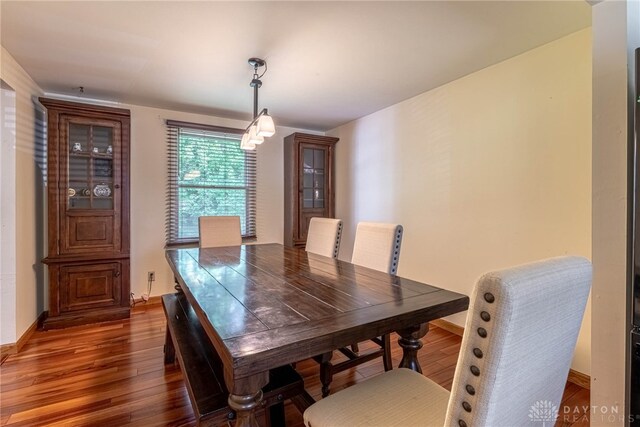 dining area featuring wood finished floors and baseboards