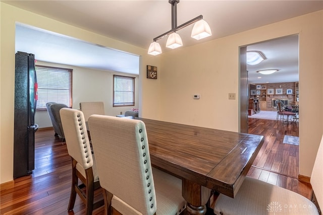 dining room with dark wood-type flooring