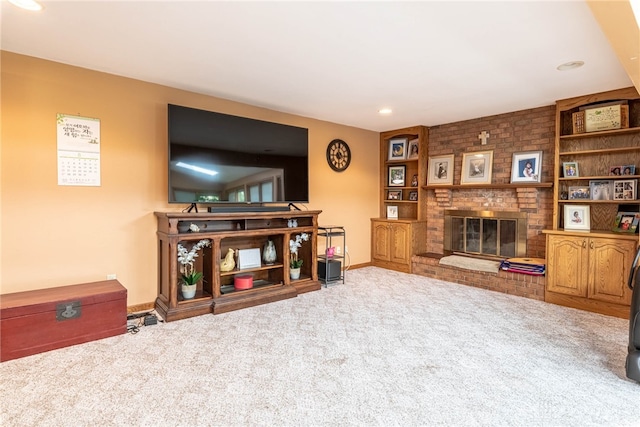 living room featuring carpet flooring, a fireplace, baseboards, and recessed lighting