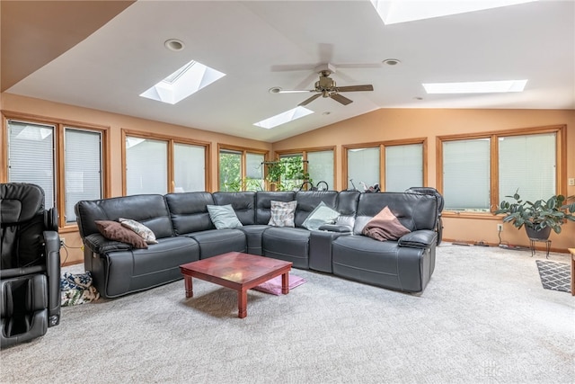 carpeted living room featuring a skylight, lofted ceiling, and ceiling fan