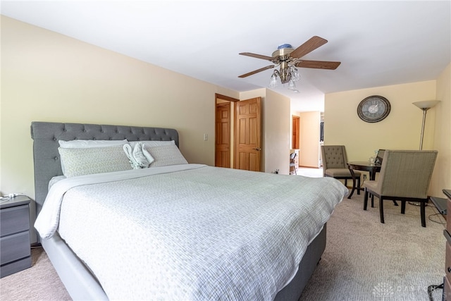 bedroom with light colored carpet and a ceiling fan