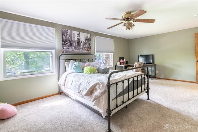 bedroom with multiple windows, carpet floors, and ceiling fan