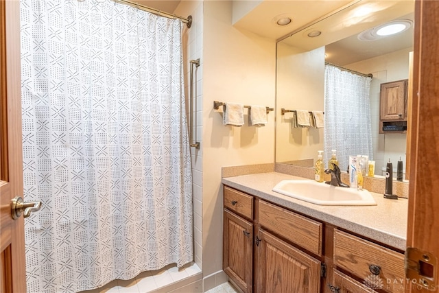 bathroom featuring vanity and curtained shower