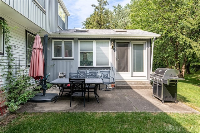 back of house featuring board and batten siding, a patio area, entry steps, and a shingled roof