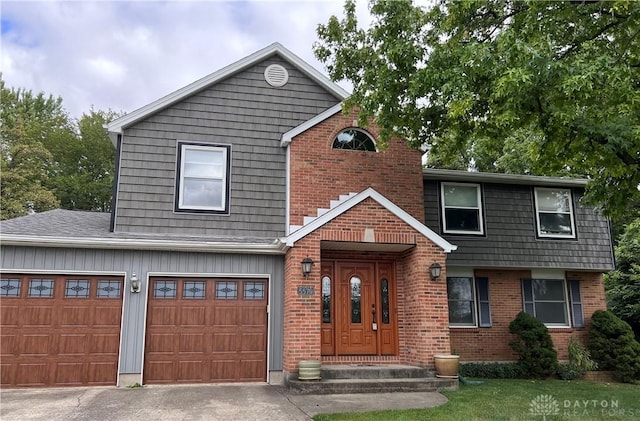 view of front of home with driveway, brick siding, and a garage