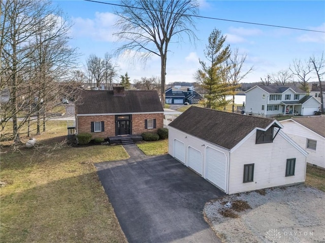 view of front of home featuring an outbuilding, a garage, brick siding, a residential view, and a chimney