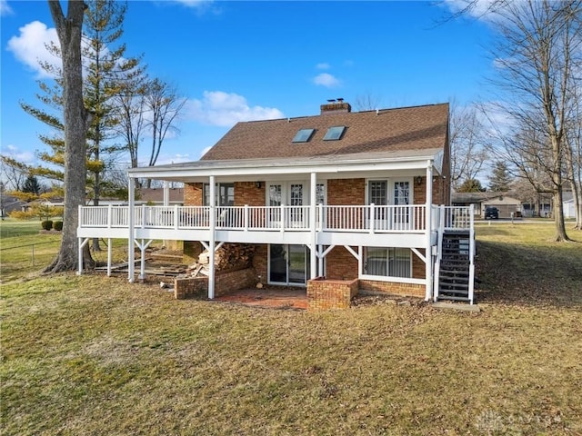 back of property featuring brick siding, a shingled roof, stairs, a yard, and a chimney