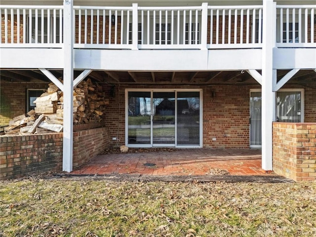 exterior space featuring a patio and brick siding