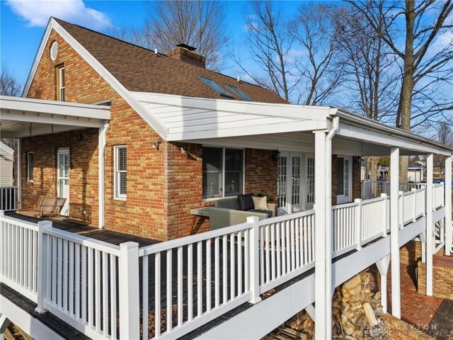 rear view of house featuring an outdoor living space and covered porch