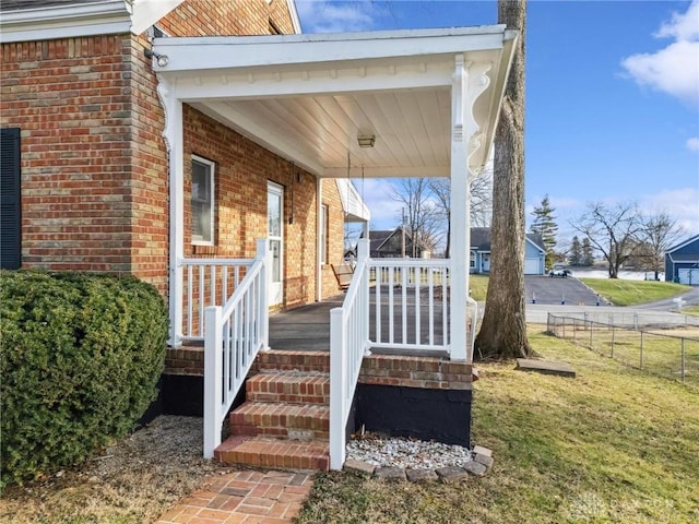 doorway to property featuring a lawn