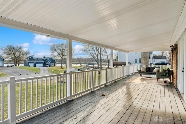 wooden terrace featuring a yard