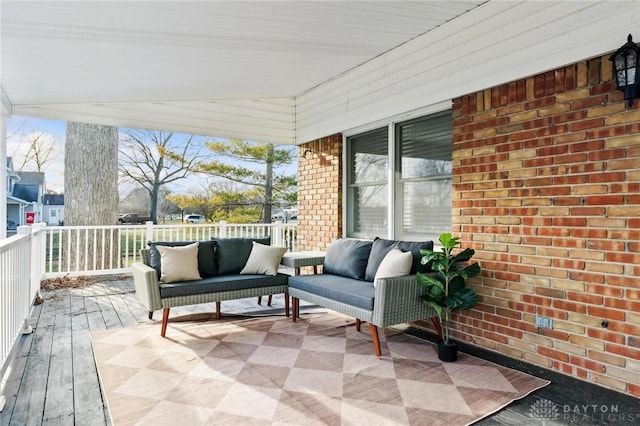 wooden deck with an outdoor living space