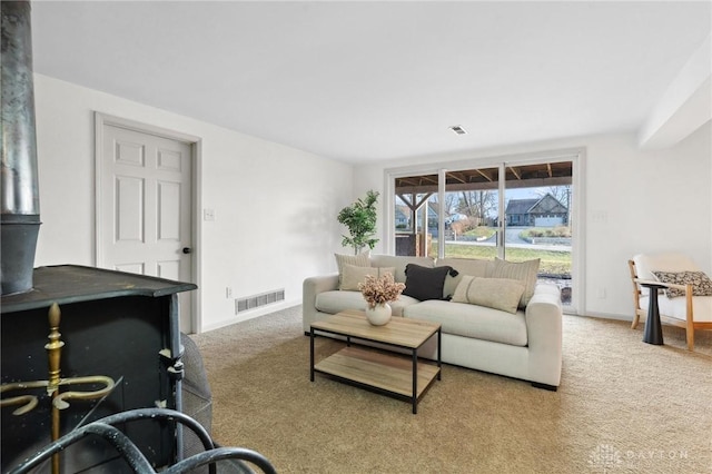 carpeted living room featuring a wood stove