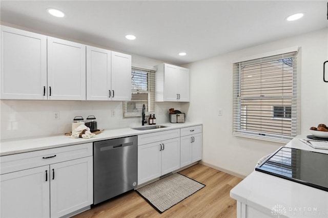 kitchen with white cabinetry, dishwasher, sink, and light wood-type flooring