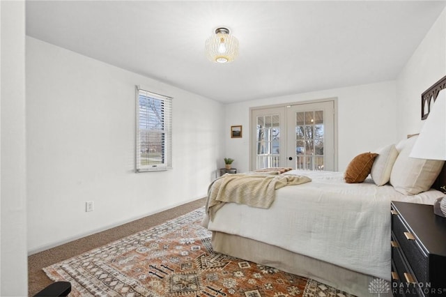 bedroom with french doors, access to exterior, and carpet floors