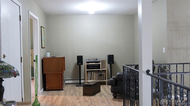 interior space with light wood-type flooring and baseboard heating